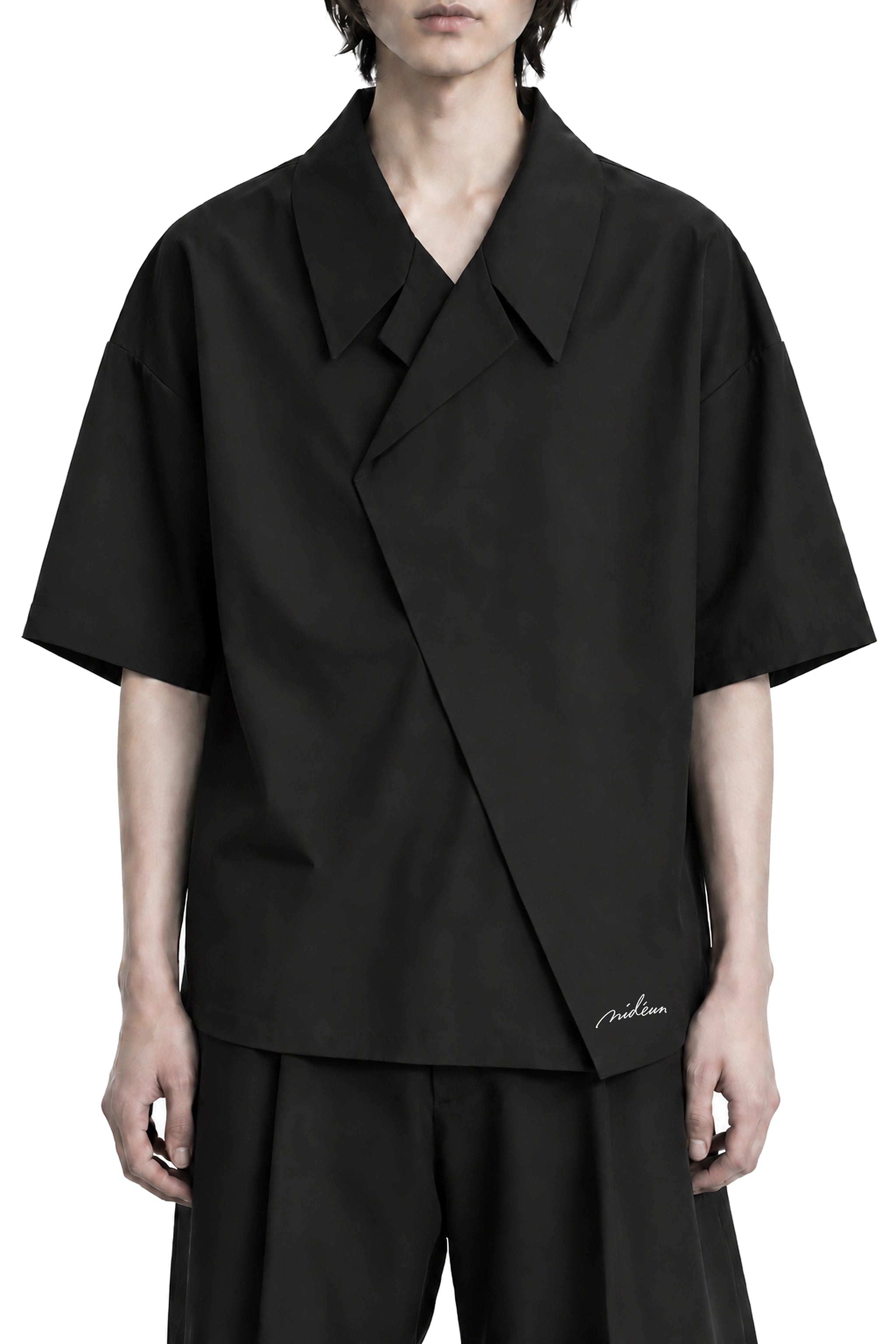 The Wrap Shirt front silhouette with asymmetric closure and white MIDÉUM embroidery
